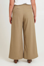 Model Chanel wearing size 16 of the High Flying Wide Leg Pants in colour Pumice, from the back