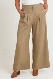 Model Chanel wearing size 16 of the High Flying Wide Leg Pants in colour Pumice, from the front, cropped image