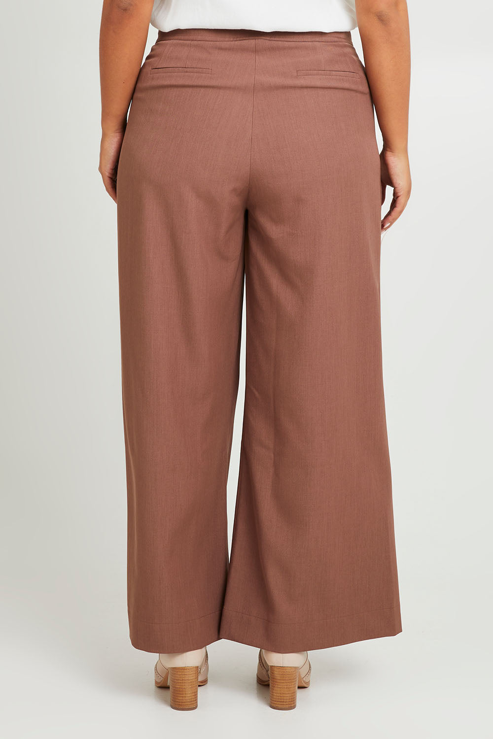 Model Monique wearing size 14 of the High Flying Wide Leg Pants in colour Walnut, from the back