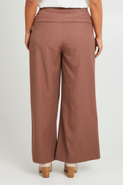 Model Monique wearing size 14 of the High Flying Wide Leg Pants in colour Walnut, from the back