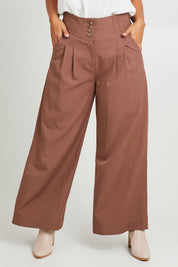 Model Monique wearing size 14 of the High Flying Wide Leg Pants in colour Walnut, from the front, cropped image