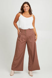 Model Monique wearing size 14 of the High Flying Wide Leg Pants in colour Walnut, from the front, showing the whole outfit