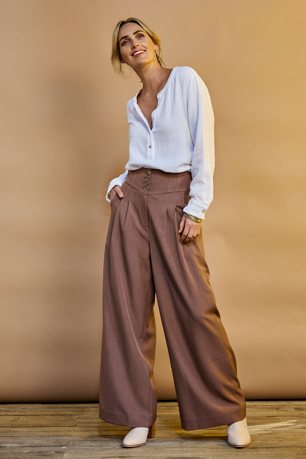 Model Tegan wearing size 10 of the High Flying Wide Leg Pants in colour Walnut, from the front, showing the whole outfit