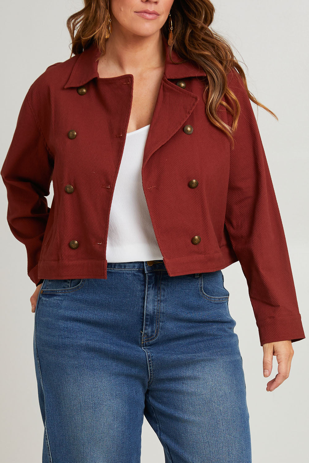 Model Laura wearing size 14 of the Coffee Date Jacket in colour Rust (Red), from the front, cropped image
