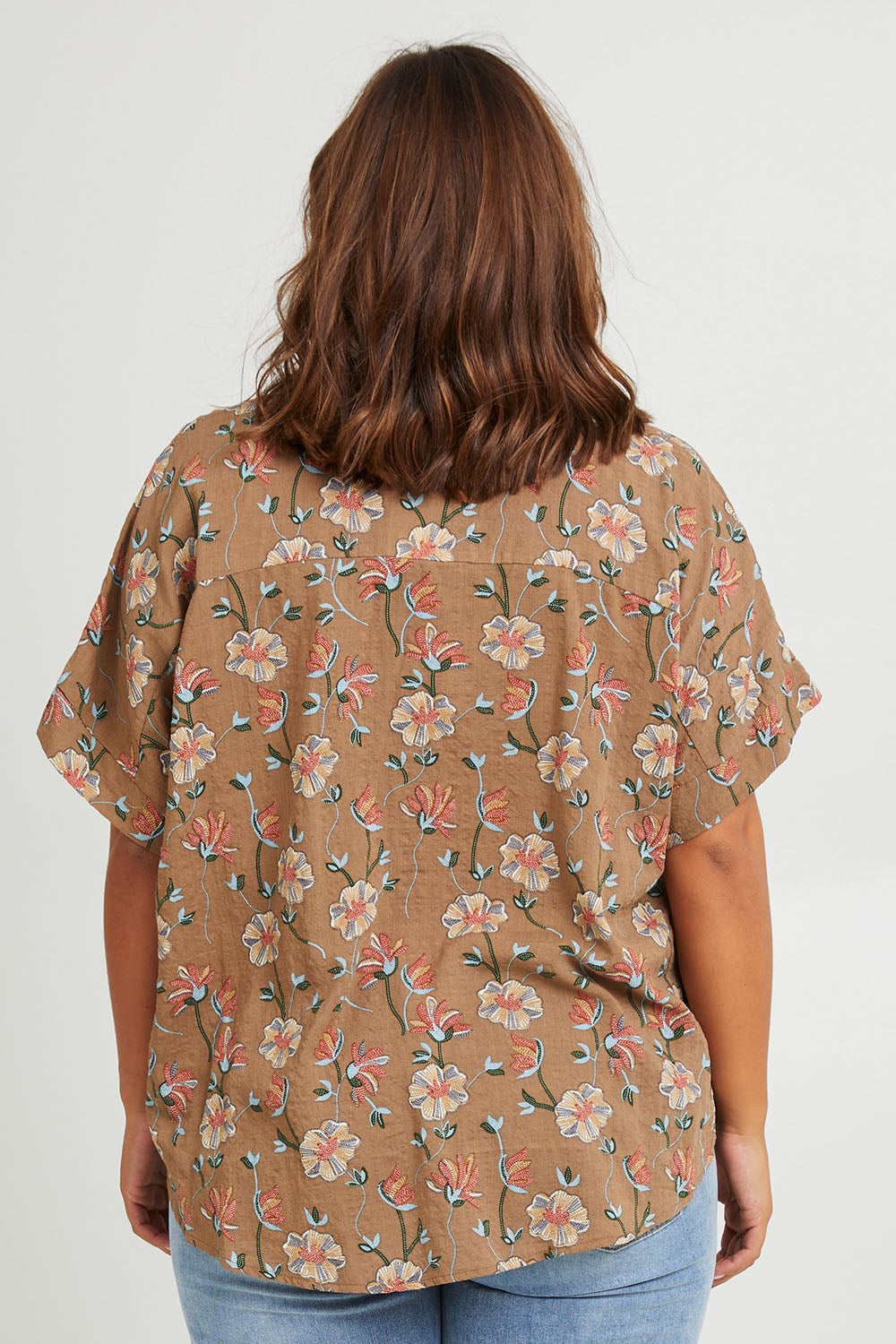 Model Monique wearing size 14 of the Flower Chain Slouch Top in colour Fleur, from the back