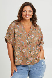 Model Monique wearing size 14 of the Flower Chain Slouch Top in colour Fleur, from the front, cropped image