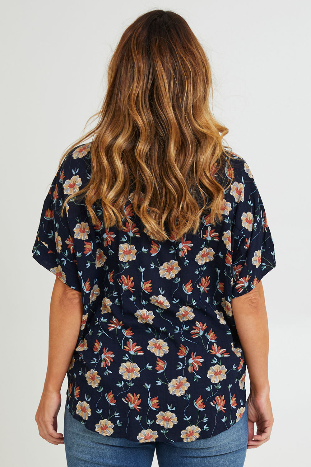 Model Laura wearing size 14 of the Flower Chain Slouch Top in colour Navy (Blue), from the back