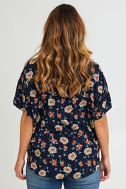 Model Laura wearing size 14 of the Flower Chain Slouch Top in colour Navy (Blue), from the back