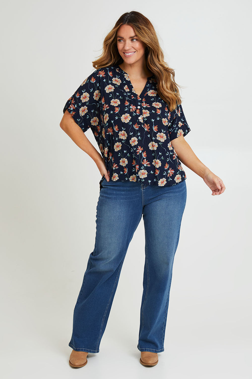 Model Laura wearing size 14 of the Flower Chain Slouch Top in colour Navy (Blue), from the front, showing the whole outfit