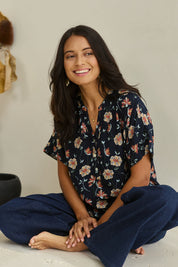 Model Tahnee wearing size 10 of the Flower Chain Slouch Top in colour Navy (Blue), from the front, showing the whole outfit