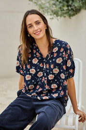 Model Tegand wearing size 10 of the Flower Chain Slouch Top – Navy in colour Navy, in a cropped view