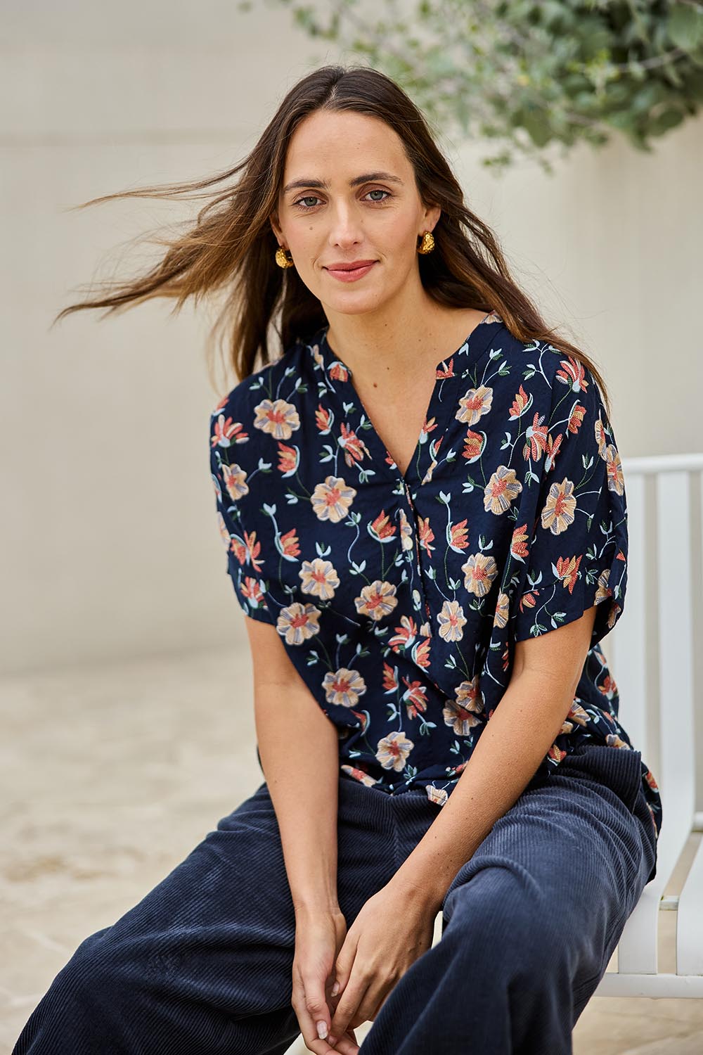 Model Tegand wearing size 10 of the Flower Chain Slouch Top – Navy in colour Navy, in a cropped view