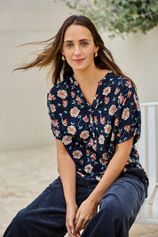 Model Tegand wearing size 10 of the Flower Chain Slouch Top – Navy in colour Navy, in a cropped view