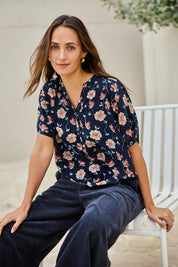 Model Tegand wearing size 10 of the Flower Chain Slouch Top – Navy in colour Navy, in a cropped view