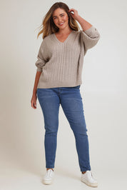 Model Chanel wearing size XL of the Ready And Cable Jumper in colour Sand, from the front, showing the whole outfit