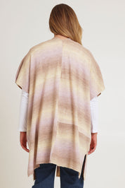 Model Chanel wearing the Mountain Fields Cardi in colour Sunset (Pink), from the back