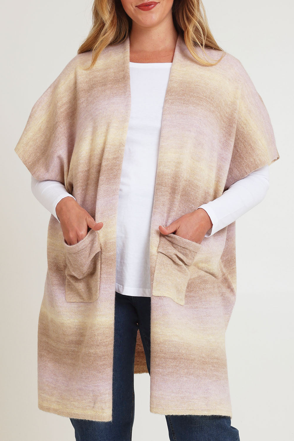 Model Chanel wearing the Mountain Fields Cardi in colour Sunset (Pink), from the front, cropped image