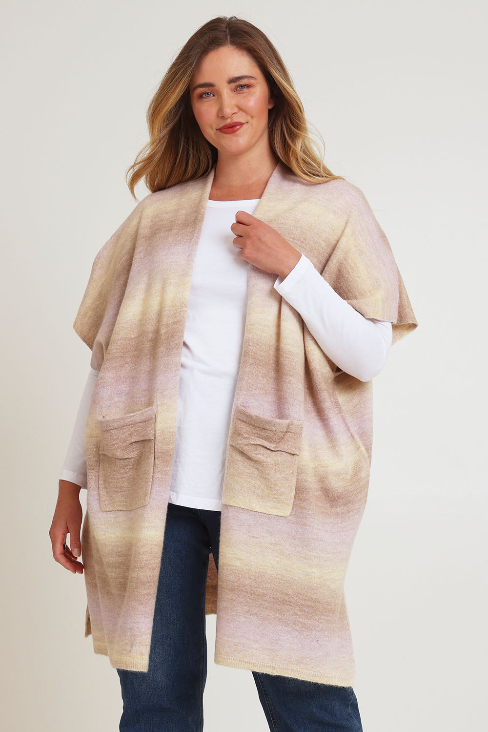 Model Chanel wearing the Mountain Fields Cardi in colour Sunset (Pink), from the front, cropped image