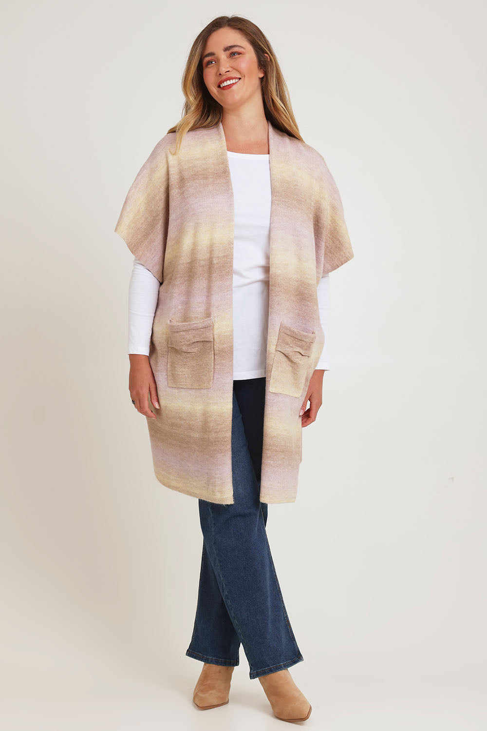 Model Chanel wearing the Mountain Fields Cardi in colour Sunset (Pink), from the front, showing the whole outfit
