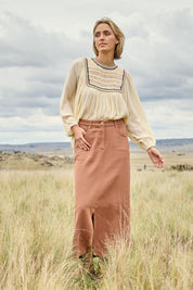 Model Tegan wearing size 10 of the Carry Me With You Maxi Skirt in colour Rosewood, from the front, showing the whole outfit