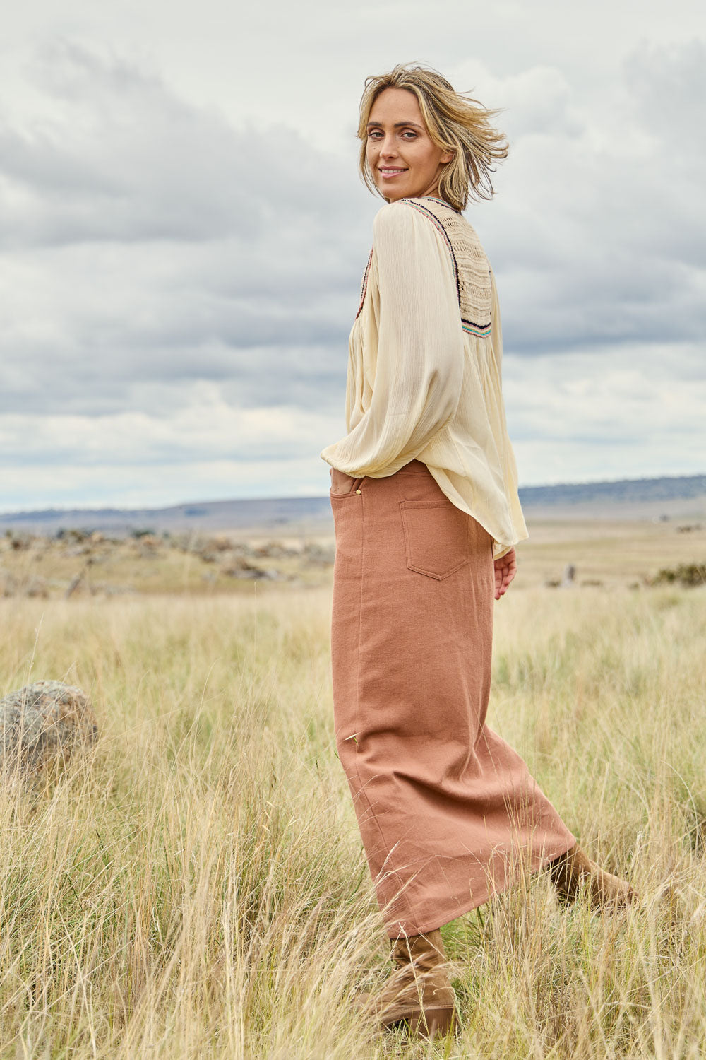 Model Tegan wearing size 10 of the Carry Me With You Maxi Skirt in colour Rosewood, from the front, showing the whole outfit