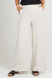 Model Luisa wearing size 10 of the Striding Out Wide Leg Pants in colour Moet, from the front, cropped image