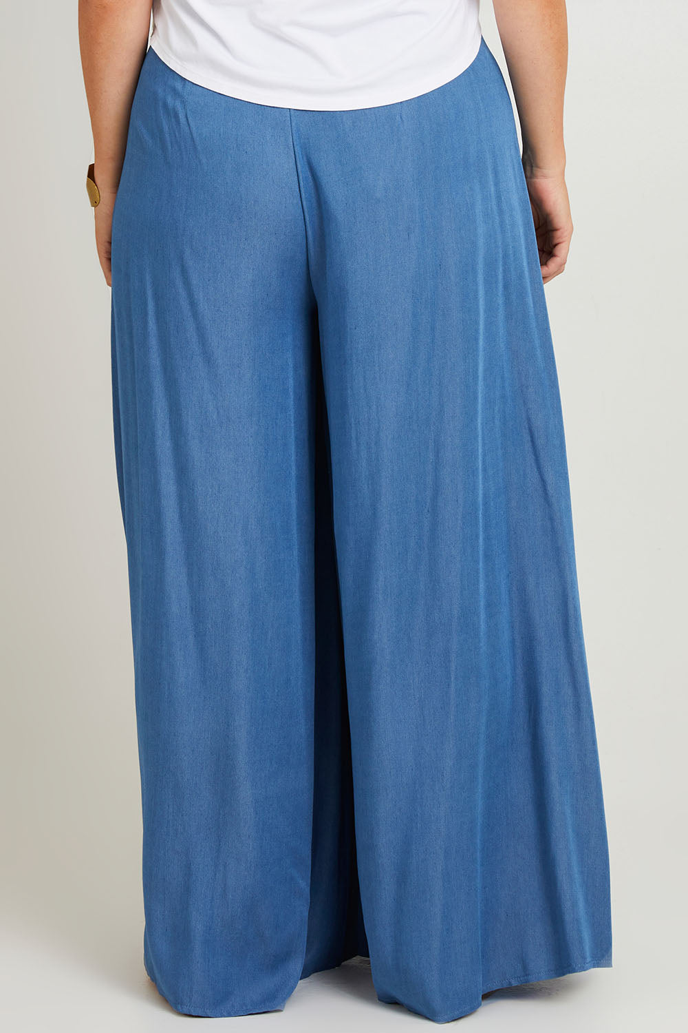 Model Laura wearing size 14 of the Easy Days Wide Leg Pants in colour Indigo (Blue), from the back