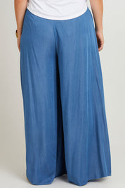 Model Laura wearing size 14 of the Easy Days Wide Leg Pants in colour Indigo (Blue), from the back