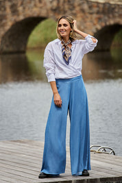 Model Tegan wearing size 10 of the Easy Days Wide Leg Pants in colour Indigo (Blue), from the front, showing the whole outfit