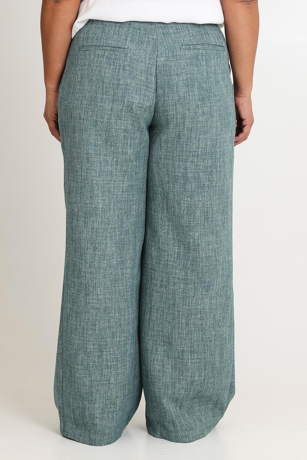 Model Ashleigh wearing size 16 of the Blazing Trails Pants in colour Duskgreen (Green), from the back