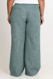 Model Ashleigh wearing size 16 of the Blazing Trails Pants in colour Duskgreen (Green), from the back