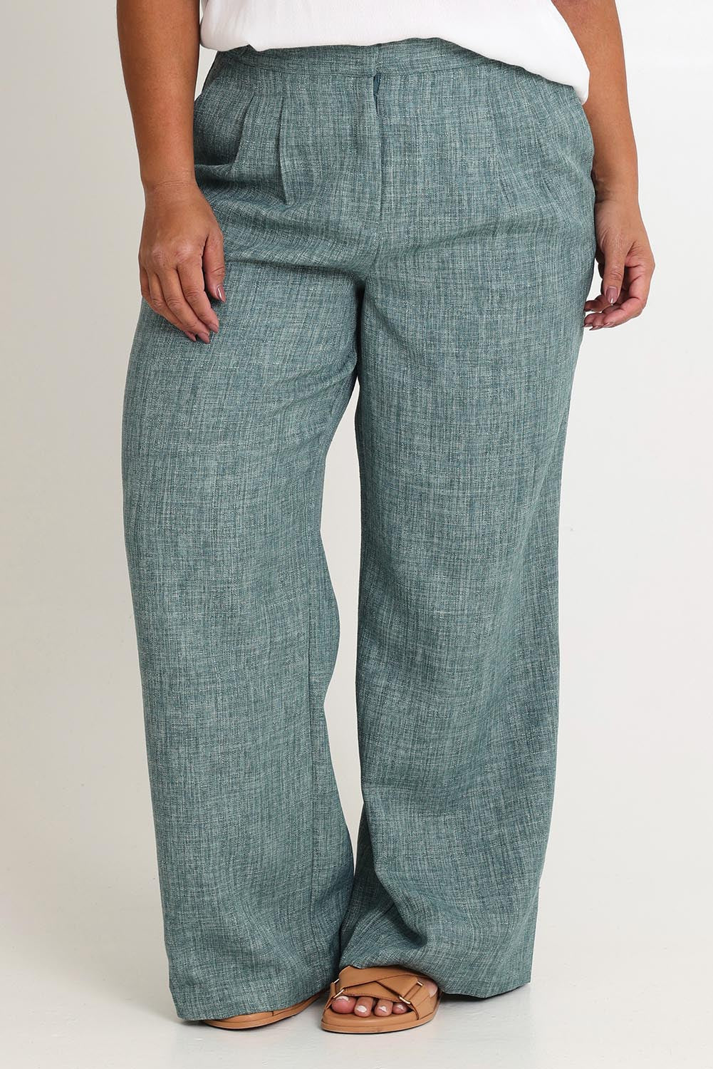 Model Ashleigh wearing size 16 of the Blazing Trails Pants in colour Duskgreen (Green), from the front, cropped image