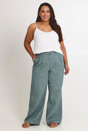 Model Ashleigh wearing size 16 of the Blazing Trails Pants in colour Duskgreen (Green), from the front, showing the whole outfit