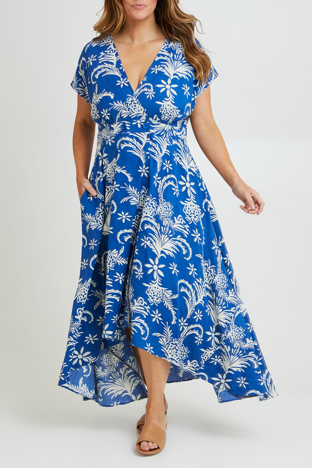Model Laura wearing size 14 of the Double Take Wrap Dress in colour Bluefleur (Blue), from the front, cropped image