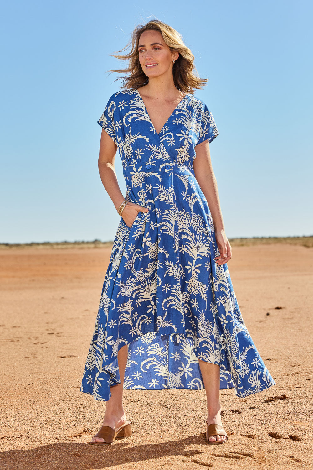 Model Tegan wearing size 10 of the Double Take Wrap Dress in colour Bluefleur (Blue), from the front, showing the whole outfit