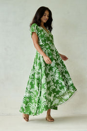 Model Tahnee wearing size 10 of the Double Take Wrap Dress in colour Grnfleur (Green), from the front, showing the whole outfit