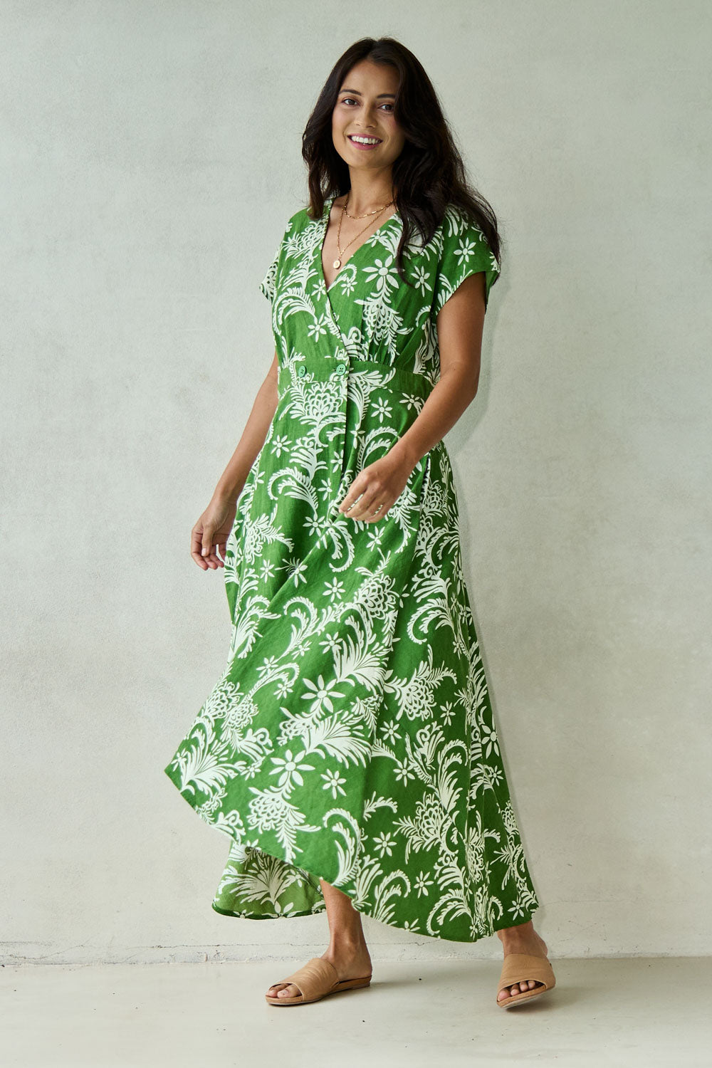 Model Tahnee wearing size 10 of the Double Take Wrap Dress in colour Grnfleur (Green), from the front, showing the whole outfit