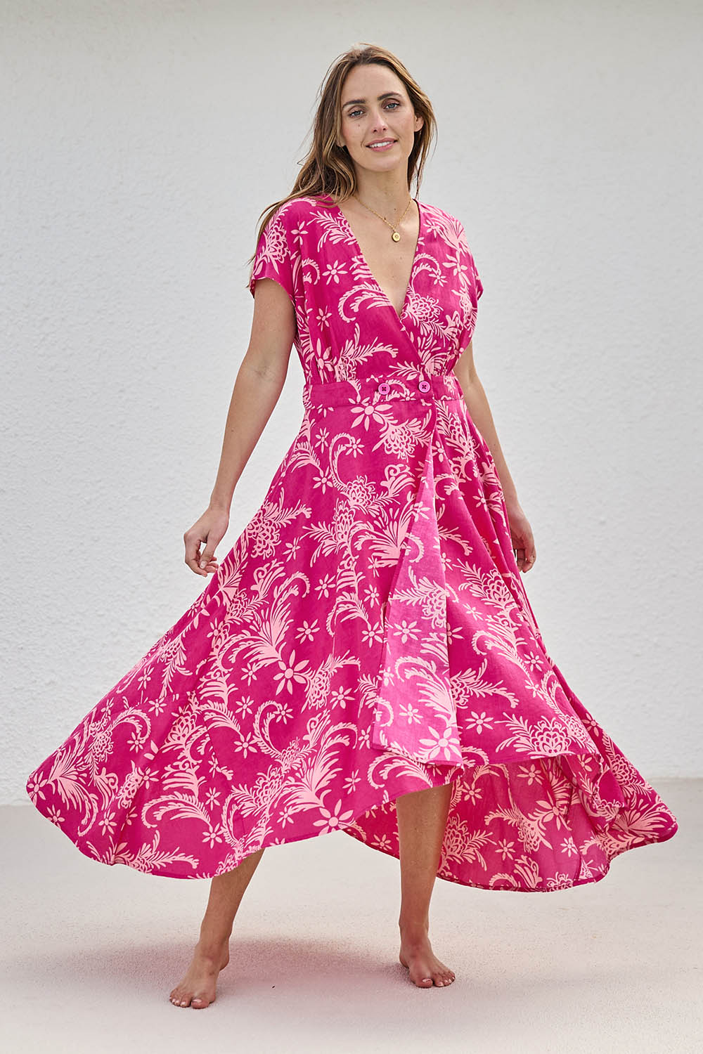 Model Tegand wearing size 10 of the Double Take Wrap Dress - Pinkfleur in colour Pinkfleur, from the front