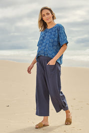 Model Tegan wearing size 10 of the You Had Me At First Glance Pants in colour Indigo (Blue), from the front, showing the whole outfit