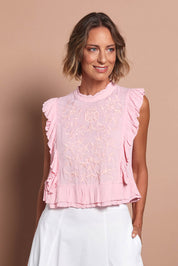 Model Riina wearing size 10 of the Easy Frills Embroidered Top in colour Blossom (Pink), from the front, cropped image
