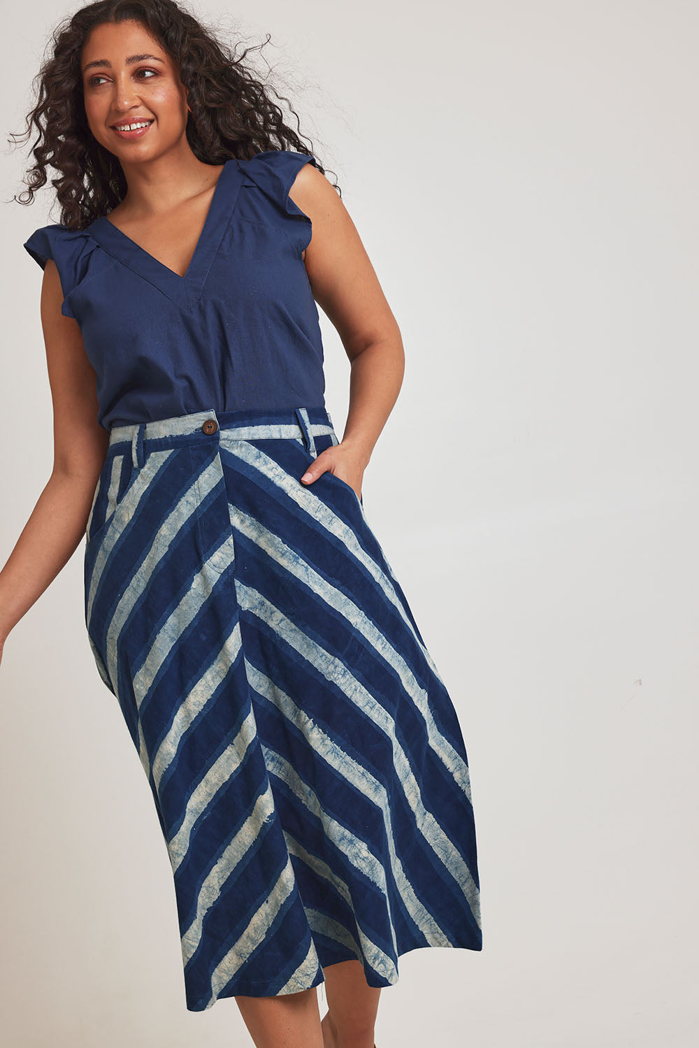 Model Terri-Leigh wearing size 14 of the Pocket Full Of Dreams Skirt in colour Stripe (Blue), from the front, cropped image