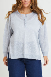 Model Laura wearing size L of the Go To Knit Boyfriend Henley in colour Sky (Blue), from the front, cropped image