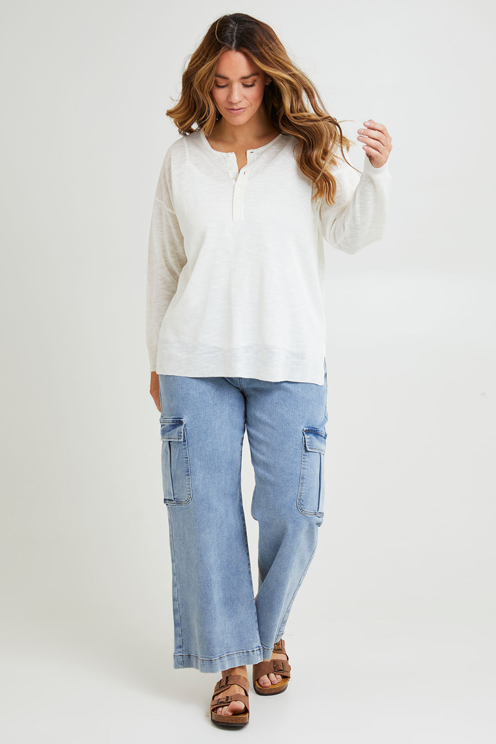 Model Laura wearing size L of the Go To Knit Boyfriend Henley in colour White (White), from the front, showing the whole outfit