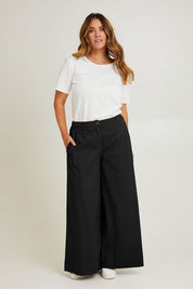 Model Laura wearing size 14 of the Need You In My Life Pants in colour Black (Black), from the front, showing the whole outfit