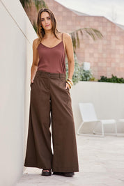 Model Tegand wearing size 10 of the Need You In My Life Pants - Cocoa in colour Cocoa, from the front