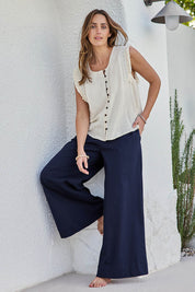 Model Tegand wearing size 10 of the Need You In My Life Pants - Navy in colour Navy, from the front