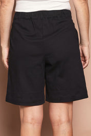 Model Katie wearing size 10 of the Need You In My Life Shorts in colour Black (Black), from the back