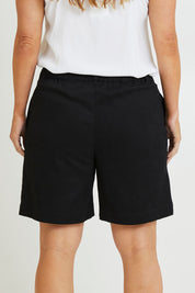 Model Laura wearing size 14 of the Need You In My Life Shorts in colour Black (Black), from the back