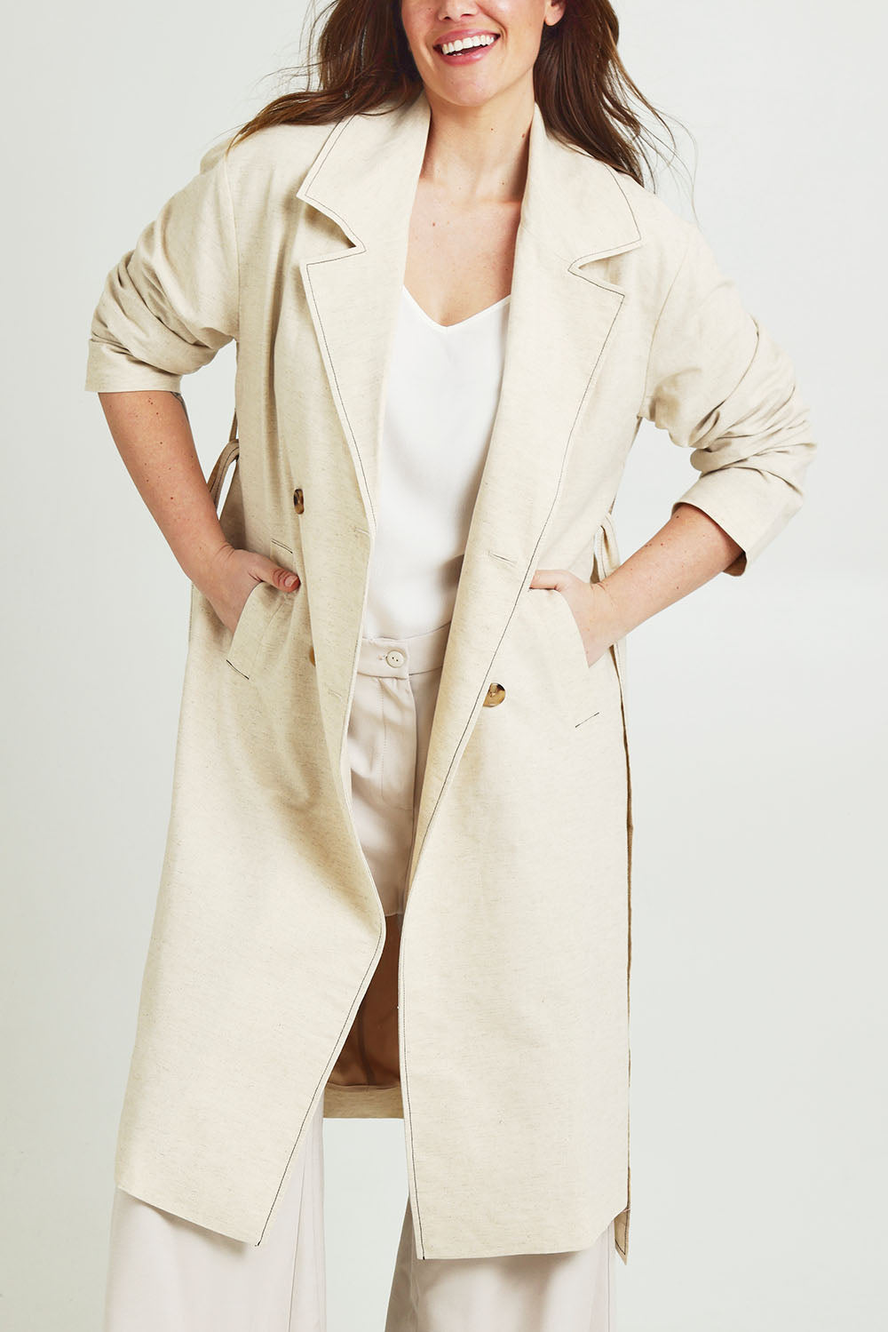 Model Jane wearing size 14 of the Summertime Love Linen Cotton Trench Coat in colour Natural, from the front, cropped image