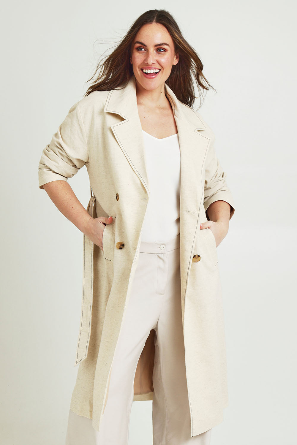 Model Jane wearing size 14 of the Summertime Love Linen Cotton Trench Coat in colour Natural, from the front, cropped image